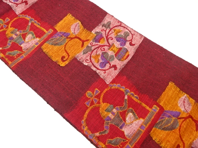 手織り紬色紙に人物・唐草模様織出し名古屋帯